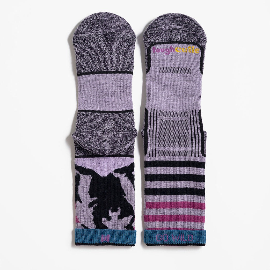 Multicolor (lavender, boysenberry, twilight blue and black) women's hiking sock featuring a black bear on the back and stripes on the front with the ToughCutie logo on the toe  and size range/go wild message inside the welt