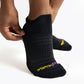 Woman wearing a black ToughCutie running sock adjusting the heel