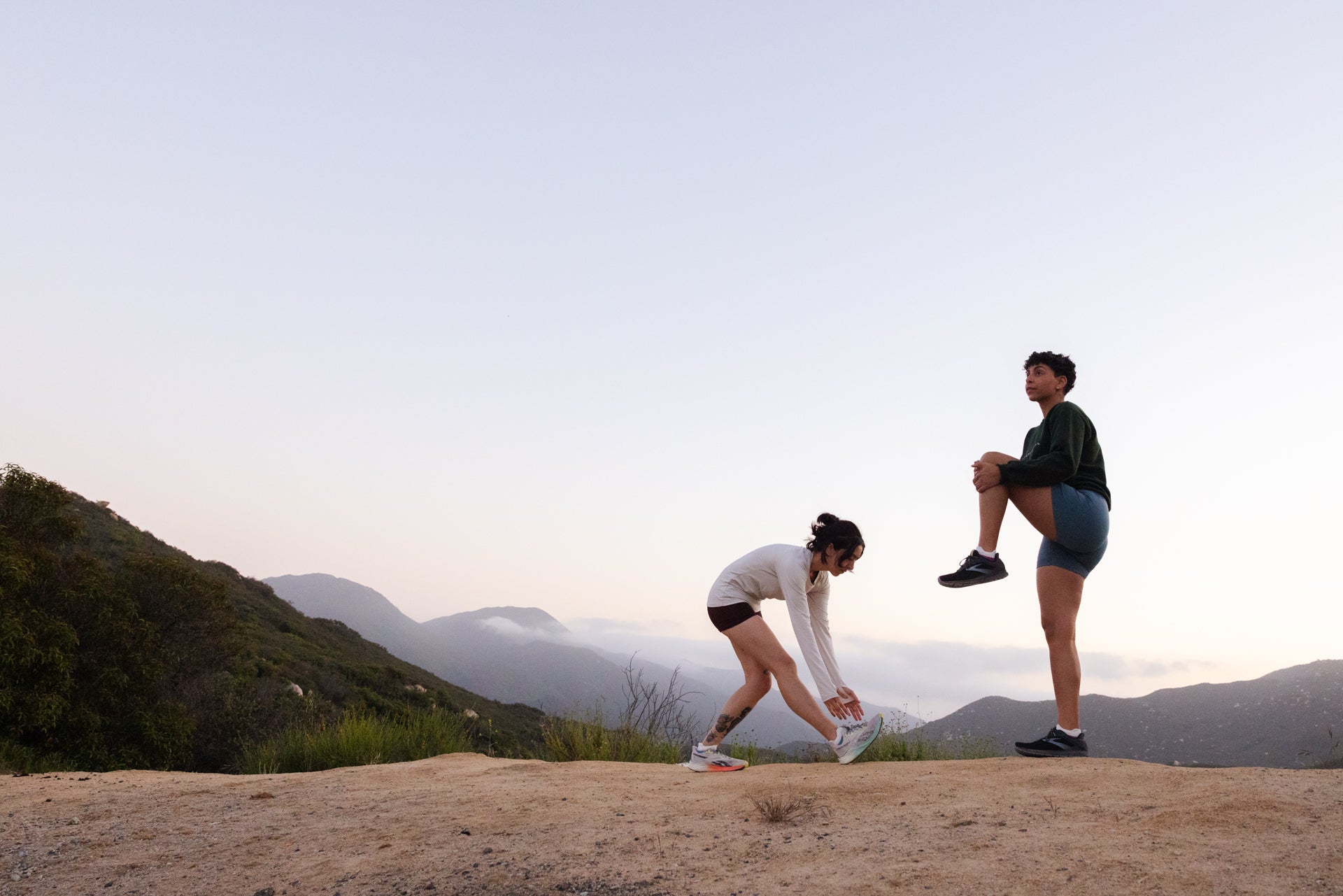 Two women stretching before a run